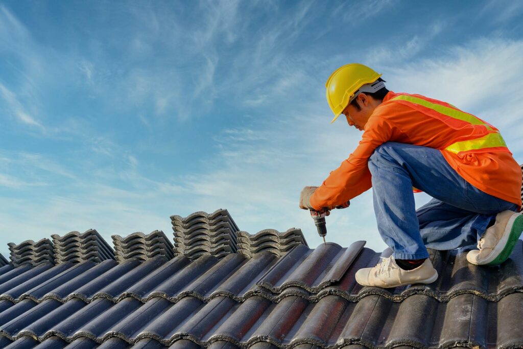 Roofer installing a tile roof